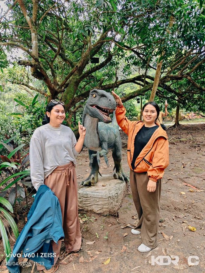 Visitors posing with a dinosaur at Dino Park