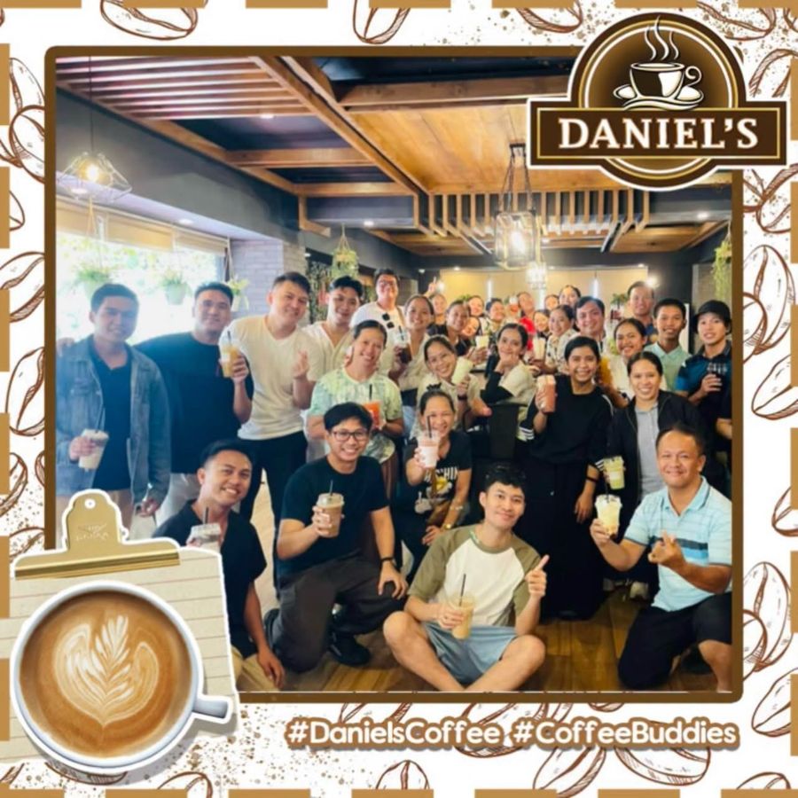Coffee buddies holding iced drinks inside Daniel’s Coffee