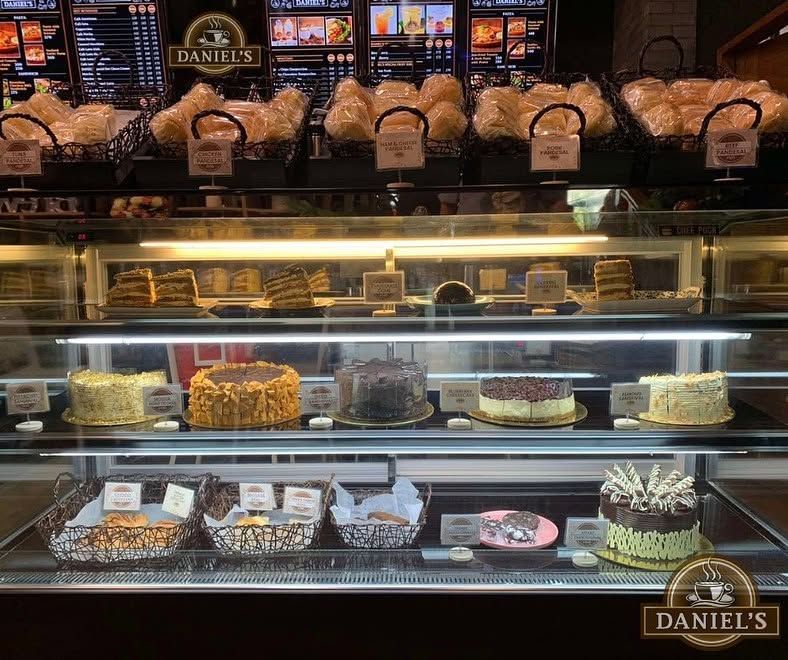 Cake and pastry display case with the menu boards above