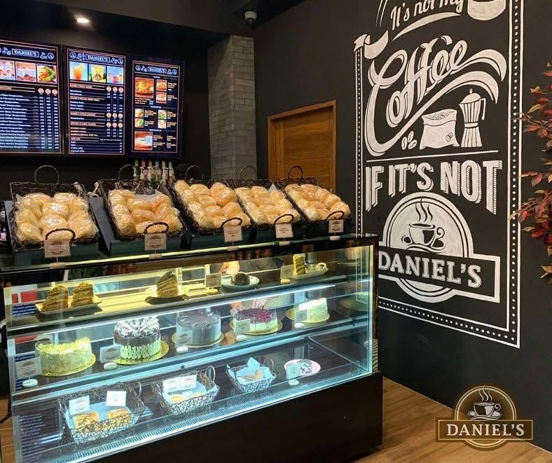 Pastry basket and cake display beside the coffee wall mural