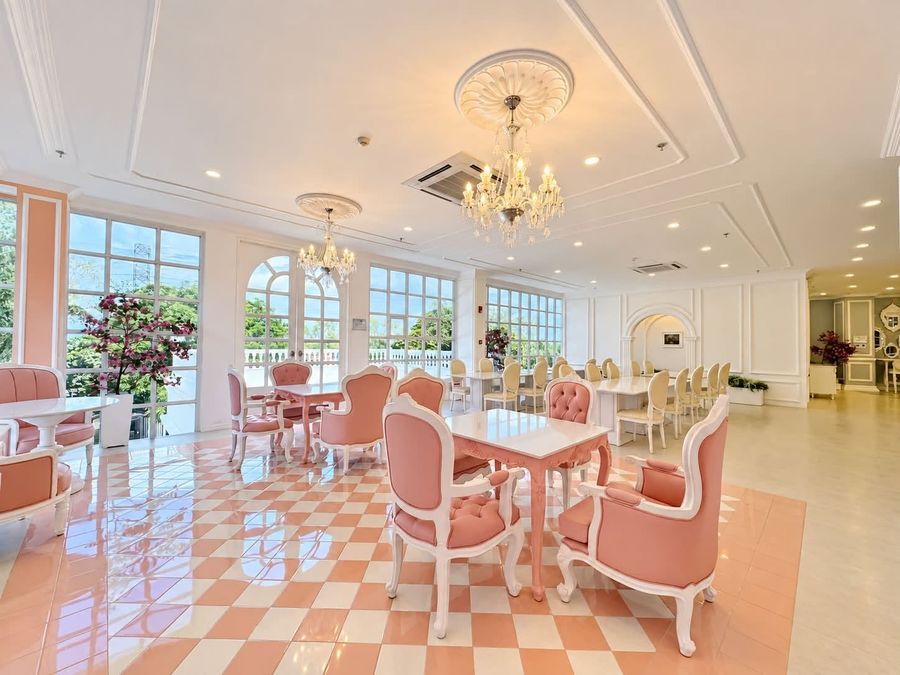 Pink and peach dining room with a checkered floor and chandelier
