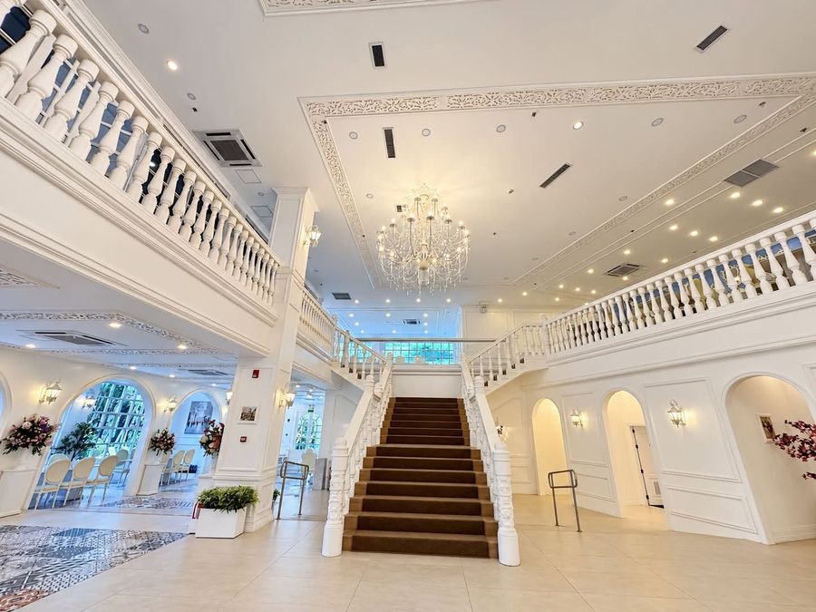 Grand staircase and arched alcoves under the chandeliers