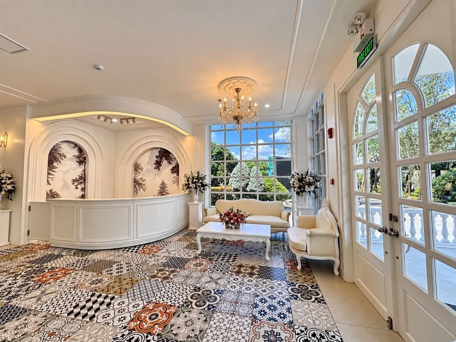 Reception area with arched mural panels and patterned tile floor