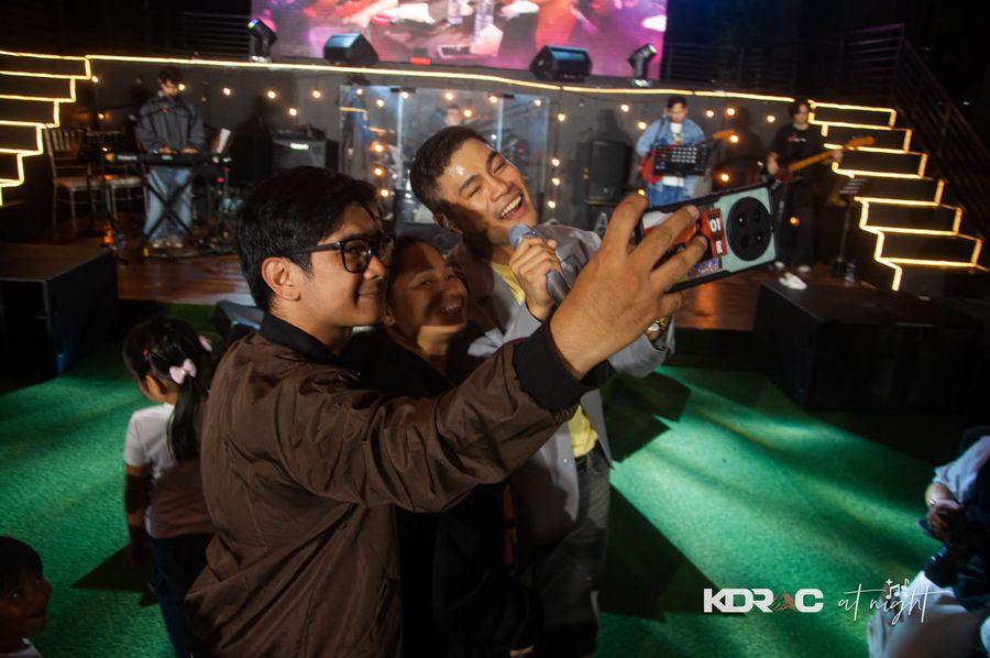 Guests and the performer taking a group selfie