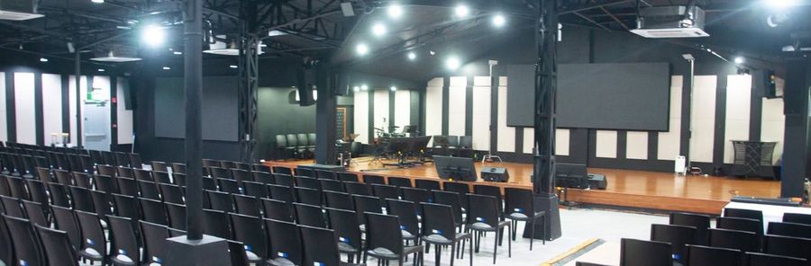 The Events Hall set up with rows of seats and stage lights